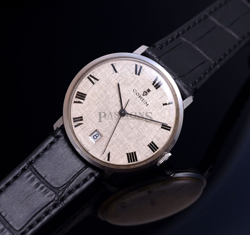 C.1970s Corum 34mm manual winding with date and silvered linen textured dial with Roman Nos in Steel